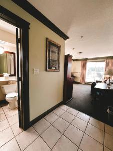 a hotel room with a toilet and a desk at Quality Inn & Suites in Hinton