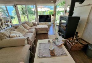 a living room with a couch and a fireplace at Countryhouse Lake Attersee - Sauna, Kamin, Seeblick in Unterach am Attersee