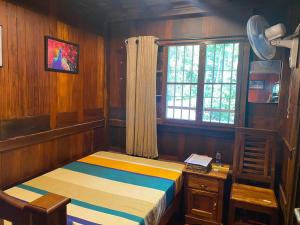 a small room with a bed and a window at Mayoorapanjaram in Neyyāttinkara
