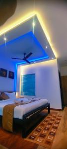 a bedroom with a bed with a blue light at MUNNAR MISTY BLOW in Munnar