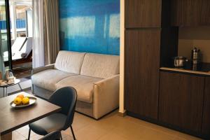 a living room with a couch and a table at Royal Antibes - Luxury Hotel, Résidence, Beach & Spa in Antibes