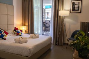 a bedroom with a bed with two towels on it at Royal Antibes - Luxury Hotel, Résidence, Beach & Spa in Antibes