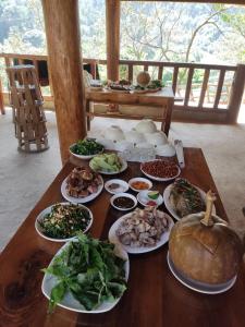 stół z wieloma talerzami jedzenia w obiekcie A Hòa Homestay w mieście Ye Yen Sun Cay