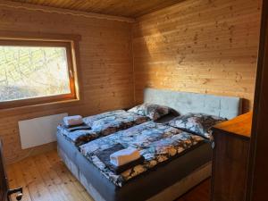 a bedroom with a bed in a wooden cabin at Ferienhaus Maximilian in Gamlitz
