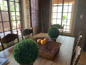 a dining room table with a basket of fruit on it at Stadigies Self-Catering Accommodation in Marloth Park