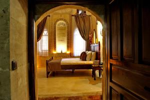 a bedroom with a bed and a large window at HH Babil Konağı in Mardin