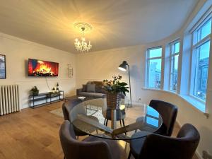 a living room with a glass table and chairs at Day Dream Laugavegur Downtown Apartments in Reykjavík