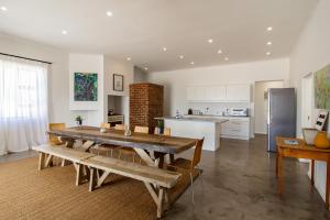a living room with a table and a kitchen at 38 on Westcliff in Hermanus