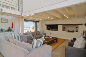 a living room with two couches and a table at 38 on Westcliff in Hermanus