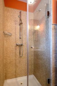 a bathroom with a shower with a glass door at La Casina in Cudillero +25 photos