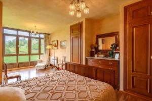 a bedroom with a large bed and a window at La Casina in Cudillero