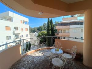 a balcony with a table and chairs and a building at Two Bedroom Condo - Just Renovated Great Location in Nicosia