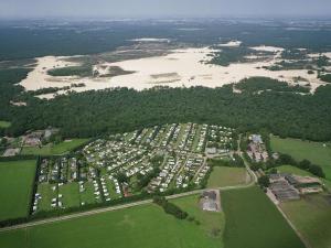 an aerial view of a large parking lot with a lake at Van Gogh-style chalet near the Loonse and Drunense Duinen in Udenhout