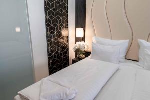 Postel nebo postele na pokoji v ubytování PLAZA Residence Wiener Neustadt