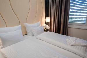 Postel nebo postele na pokoji v ubytování PLAZA Residence Wiener Neustadt