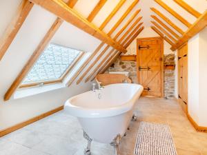 a bathroom with a tub and a window at Carnau Bach uk45822 in Llandegley
