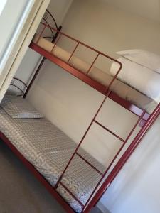 two bunk beds in a small room at Maison vacances climatisée à 20 minutes de la mer in Gallargues-Le-Montueux