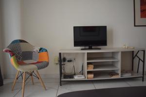 a living room with two chairs and a television at Klimentos Flat 59 in Nicosia