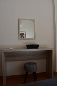 a desk with a mirror and a chair in a room at Klimentos Flat 59 in Nicosia