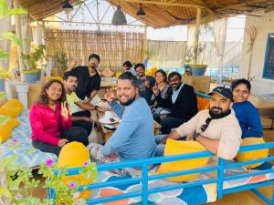 a group of people posing for a picture in a room at Jaisalmer Hostel Crowd in Jaisalmer