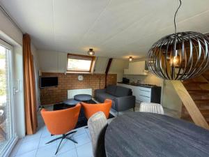a kitchen and a living room with a table and chairs at Holiday House in Friesland with Garden in Sint Nicolaasga
