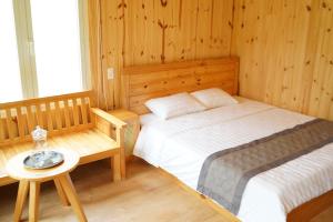 a bedroom with a bed and a table in a room at B&H Villa - Villa has swimming pool in Lang Co