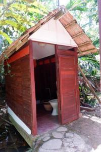 an out house with a toilet in it at Jungle Zen Janda Baik Campsite in Kampung Janda Baik