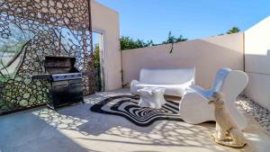 a patio with a stove and a chair and a rug at Villa Iris Javea by Rock Rentals in Balcon del Mar