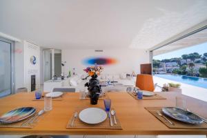 a dining room with a table and a pool at Villa Iris Javea by Rock Rentals in Balcon del Mar