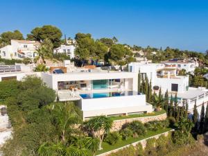 an aerial view of a white house with a swimming pool at Villa Iris Javea by Rock Rentals in Balcon del Mar