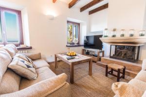 a living room with a couch and a fireplace at Finca Relax Can Mengol amazing seaview in Artá