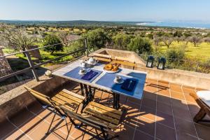 a table and chairs on the balcony of a house at Finca Relax Can Mengol amazing seaview in Artá