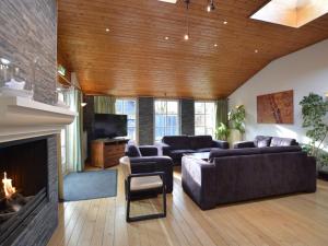 a living room with couches and a fireplace at Welcoming Mansion near Forest in Bergeijk in Bergeijk