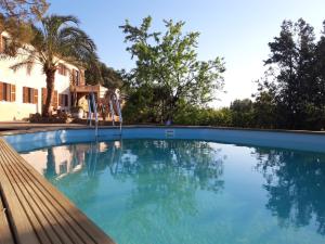 a swimming pool with blue water in front of a house at Finca Relax Can Mengol amazing seaview in Artá