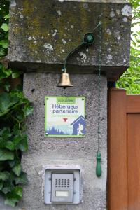 a sign on the side of a wall with a phone at Le Deyran in Égliseneuve-dʼEntraigues