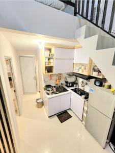 an overhead view of a kitchen with white appliances at BnB House Villa Jogja in Yogyakarta