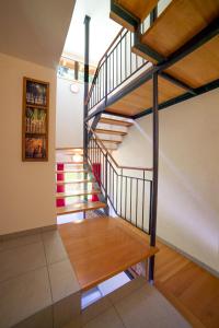 a spiral staircase in a house with wooden floors at Les Soldanelles in Salvan