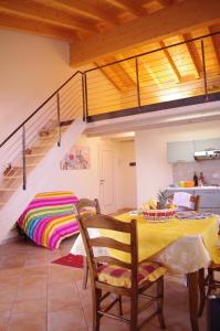 a dining room with a table and a staircase at Agriturismo La Casa Del Mandorlo in Monzambano