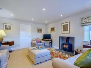 a living room with a fireplace and a couch at 1 Bed in Lockerbie 86068 in Lockerbie