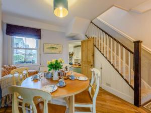 a dining room with a table and chairs and a staircase at 2 Bed in Rye 86094 in Rye