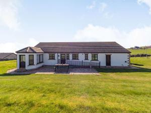 a small white house with a large grass field at 3 Bed in Berwick-upon-Tweed 87777 in Lamberton