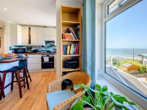 a kitchen and dining room with a view of the ocean at 4 Bed in Ogmore-By-Sea 87141 in Saint Brides Major