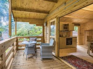 a wooden cabin with a table and chairs on a deck at 1 Bed in Ironbridge 88768 in Leighton