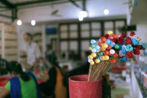 a vase filled with colorful flowers in a room at Residence De L'eveche - Entire Villa in Pondicherry- A CGH Earth SAHA Experience in Puducherry
