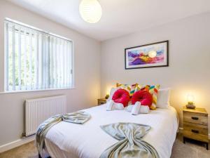 a bedroom with a large white bed with red pillows at 5 Bed in Crich 88486 in Crich