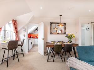 a kitchen and dining room with a table and chairs at 2 Bed in Sheringham 88076 in Sheringham