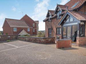 a row of brick houses with a driveway at 2 Bed in Sheringham 88076 in Sheringham