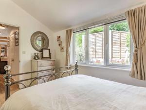 a bedroom with a bed and a large window at 1 Bed in Bodmin 88049 in Luxulyan
