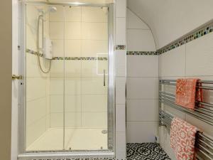 a shower with a glass door in a bathroom at 1 Bed in Wool 88099 in Wool