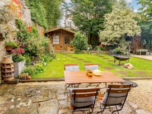 a wooden table and chairs in a garden at 2 Bed in Frome 89168 in Holcombe
